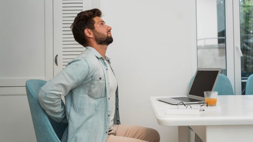 A man working at home office with bad ergonomics