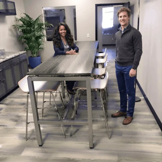 An image showing Breakroom Table and Seating and 2 people.